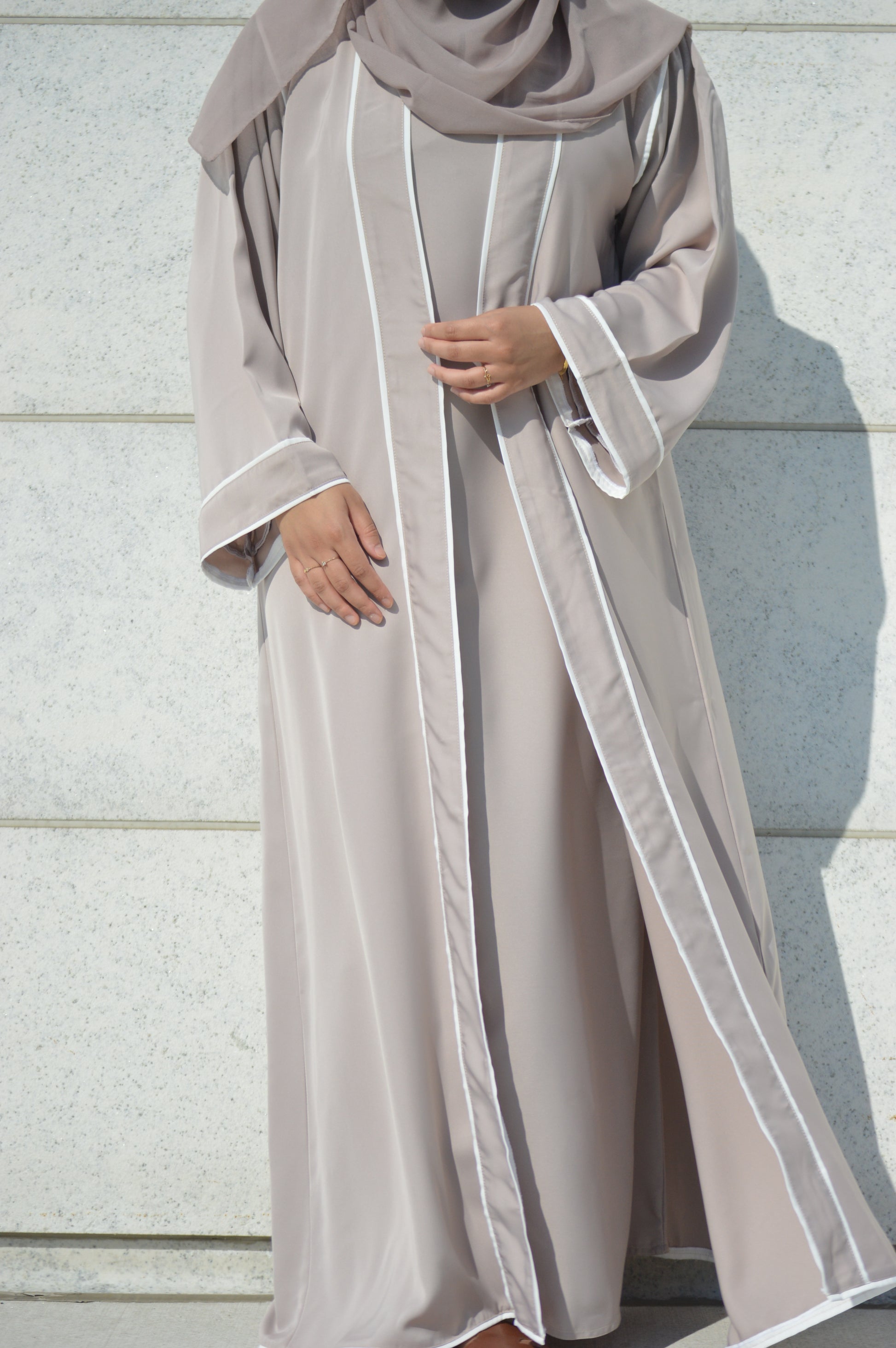 Comfortable and functional, unlined beige abaya with snaps on the